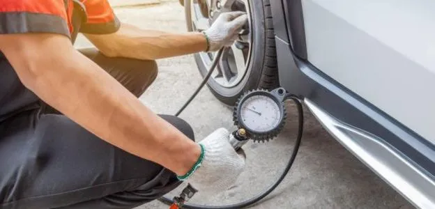 service-technician-checking-tyre-pressure